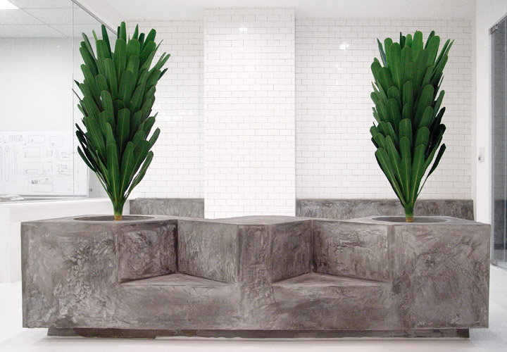 The concrete planter for the office reception area seats four and has a perch for coffee.