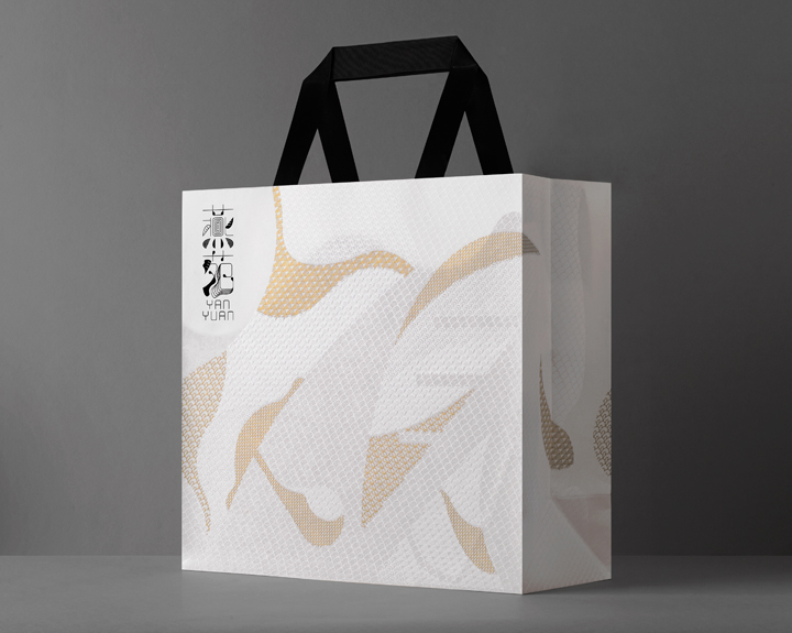 Translucent paper bag of 3 size with gold, silver and white print.
